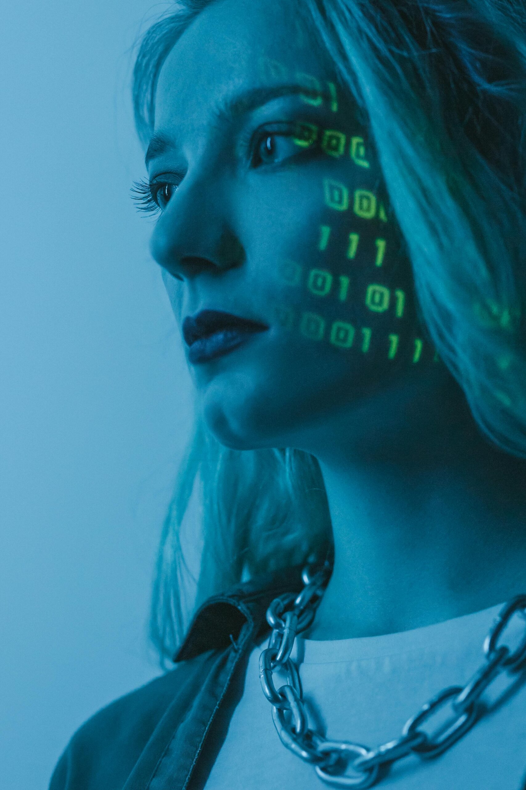 Tech-inspired portrait of a woman with digital code projected on her face, symbolizing cybersecurity.